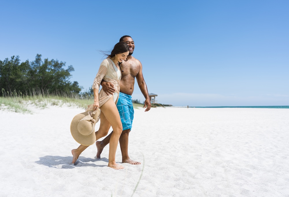 Date Night a man and woman walking on a beach