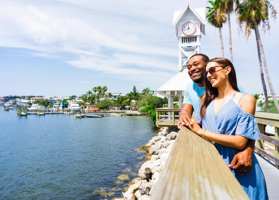 Where to see public art a man and woman standing on a railing by water