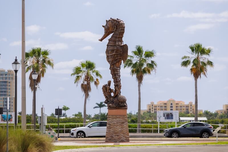 Where to see public art large metallic sculpture of a seahorse on a sunny day