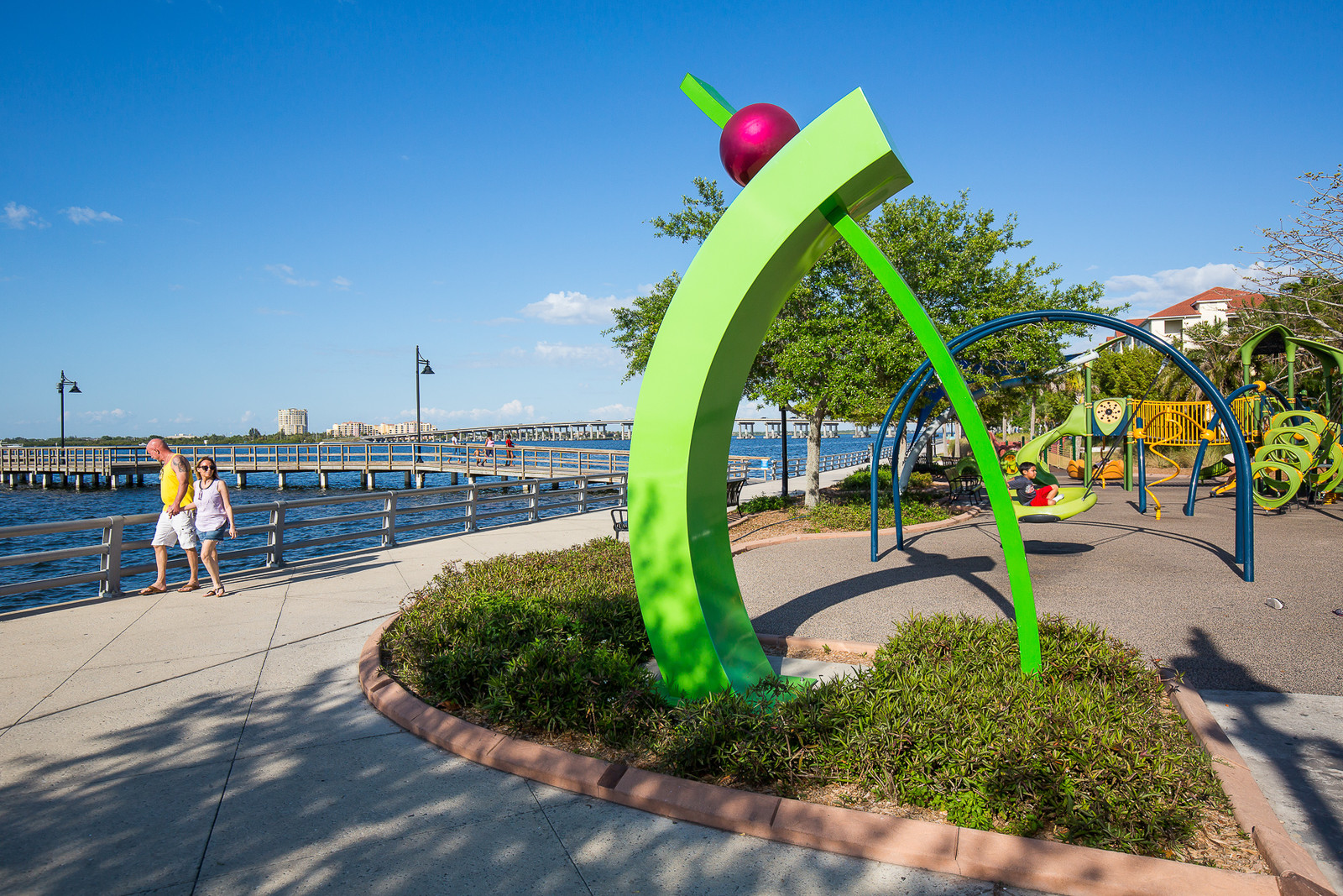 Explore the Gulf Island Ferry Stops a green sculpture with a ball on top of it and a view of the Manatee RIver