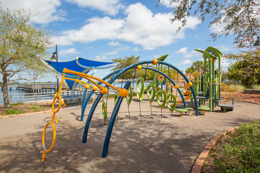 Family Adventures: Memories Made on the Gulf playground on the bradenton riverwalk with a view of the manatee river in the background