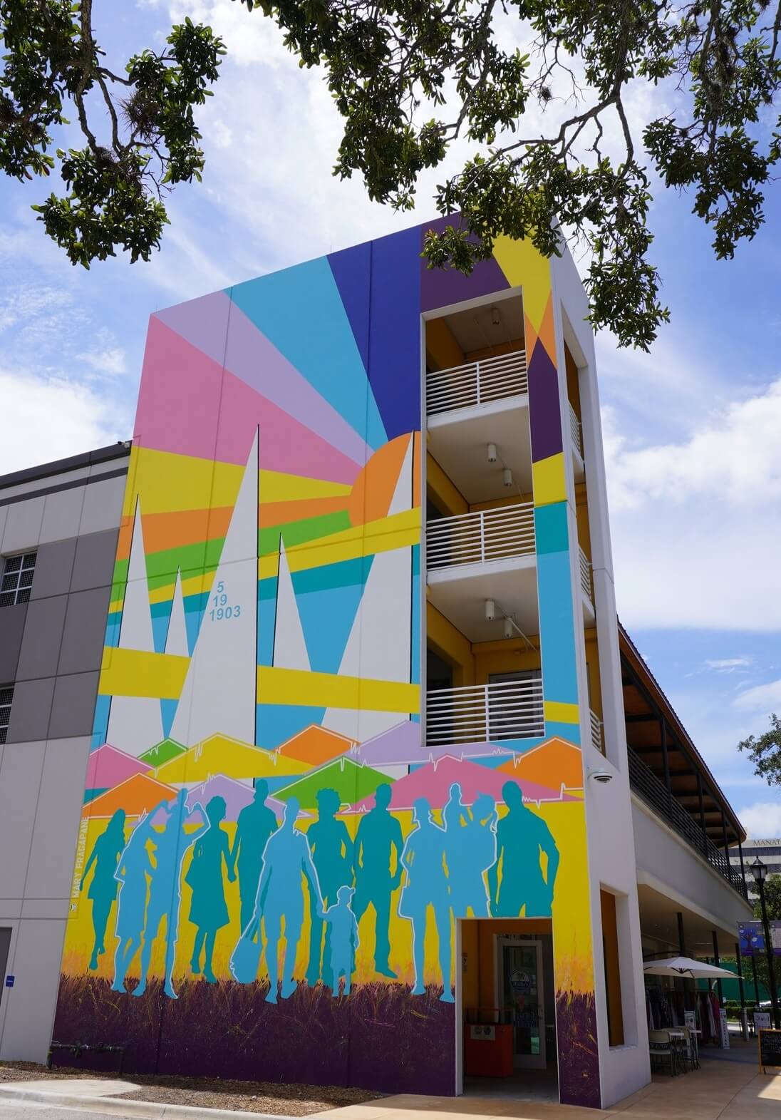 Where to see public art a multi-story building with a mural on the side