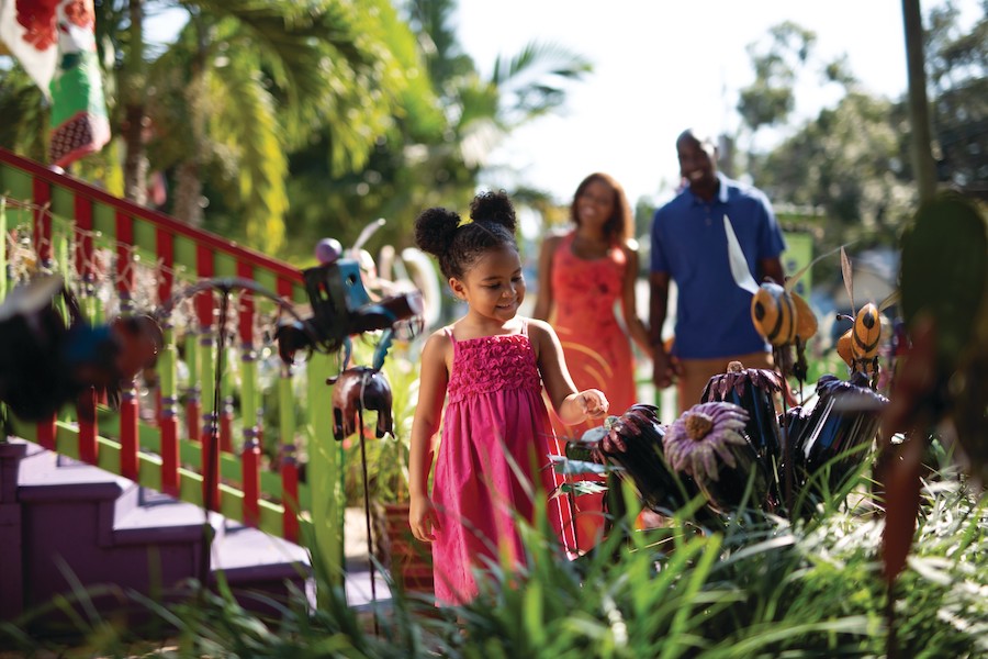 Family Adventures: Memories Made on the Gulf child looking at pretty things in village of the arts