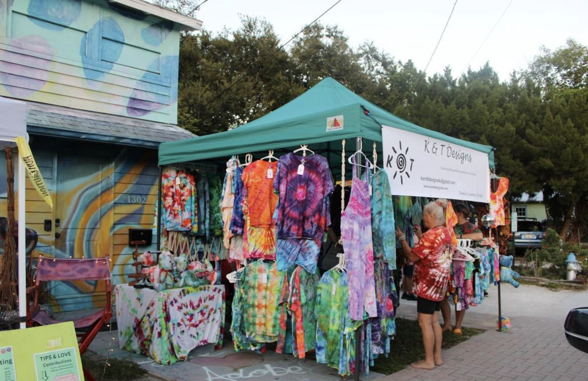 vendor outside of brightly colored painting at the 13th & 13th art market