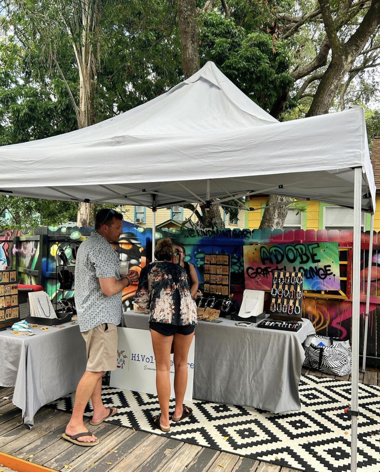 people at vendor booth at the 13th & 13th art market